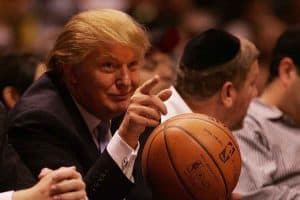 us president donald trump holding a basketball and pointing