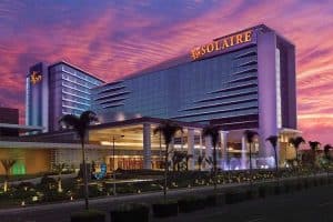 solaire casino in the philippines at sunset with a pink and orange sky